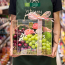 giỏ quà trái cây nho xanh, cherry và hoa tươi đựng trong vali sang trọng, lịch sự. Dành tặng đối tác, khách hàng.